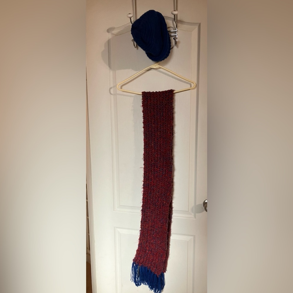 Handcrafted scarf and matching cap set. Scarf is multicolored; blue cap.